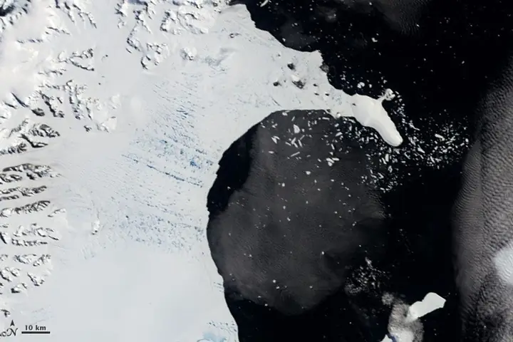 Satellite image of the intact Larsen B ice shelf, a flat white sheet bordered by dark open water.